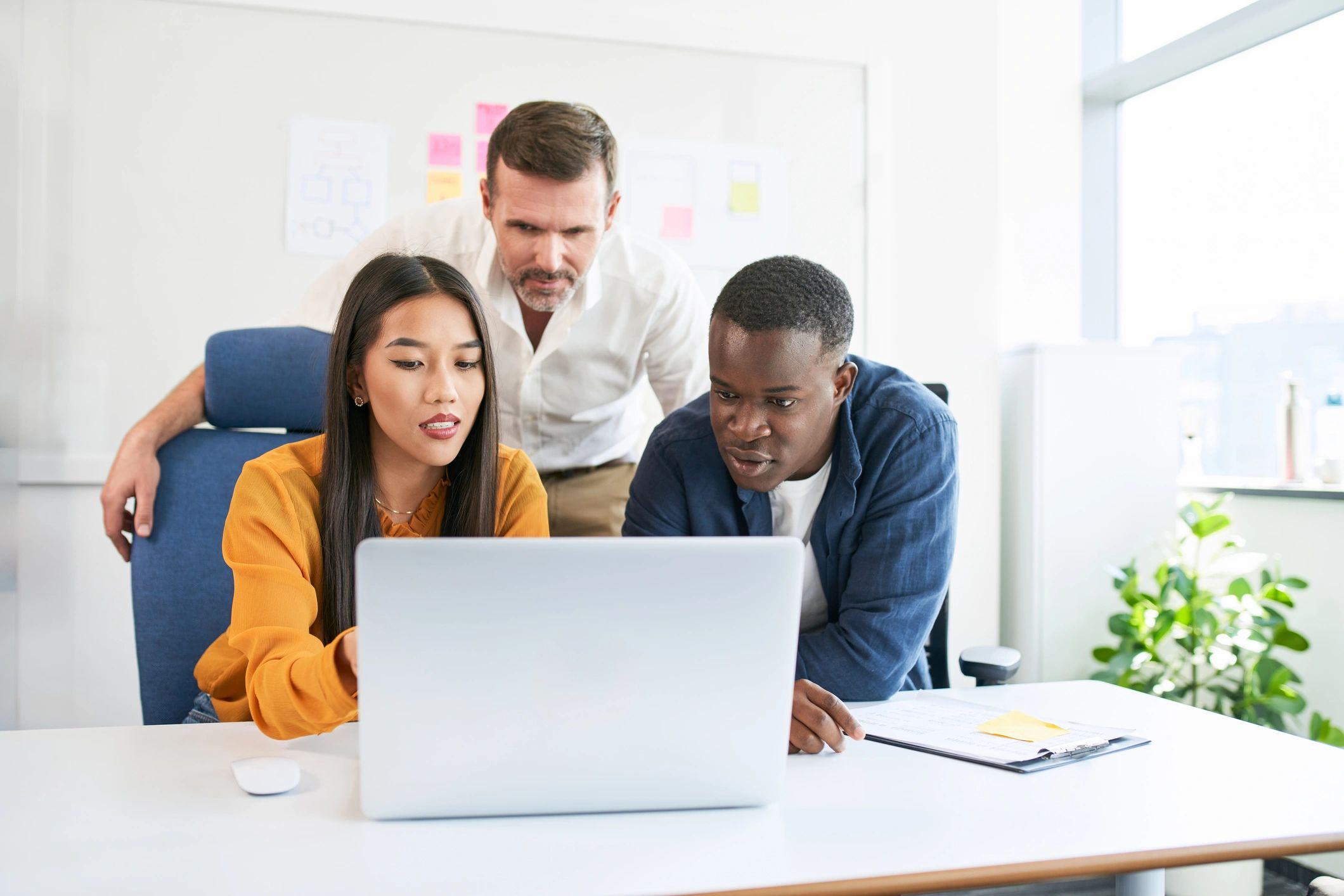 Diverse team collaborating on a project in a modern office